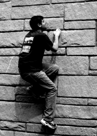 Robb climbing a rock wall